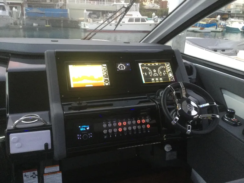 Slide: The Image of 2021 Cruisers Yachts 42 GLS OB helm with digital displays and steering wheel. - 31