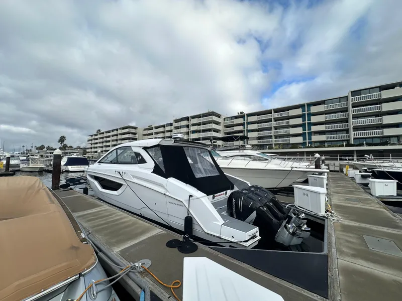 Slide: The Image of 2021 Cruisers Yachts 42 GLS OB docked at marina, cloudy sky background. - 32
