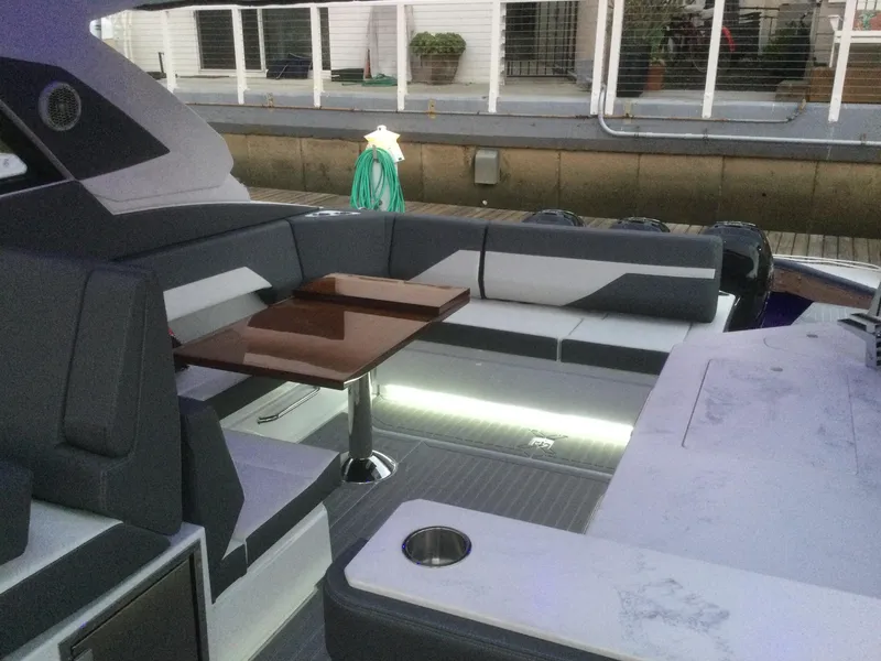 Slide: The Image of Luxurious seating area on 2021 Cruisers Yachts 42 GLS OB with sleek design and ambient lighting. - 36