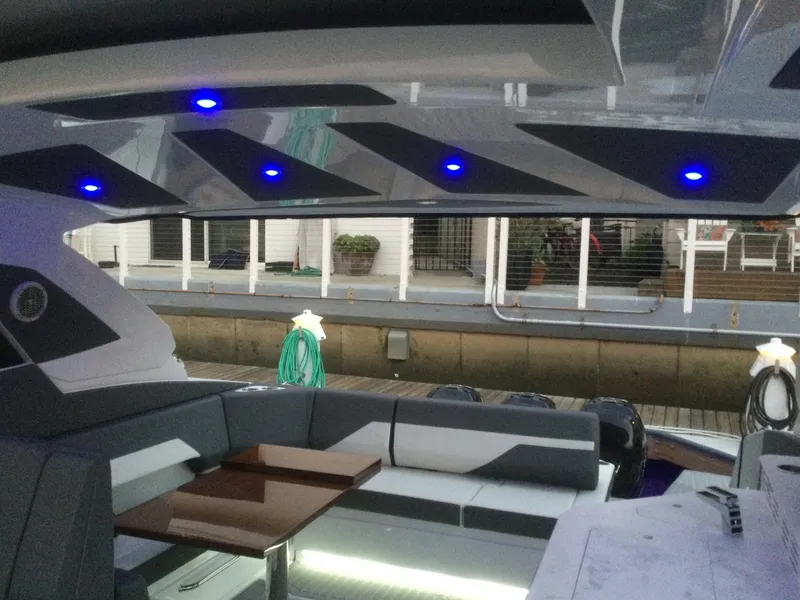 Slide: The Image of Interior of 2021 Cruisers Yachts 42 GLS OB with modern seating and blue LED lights. - 37