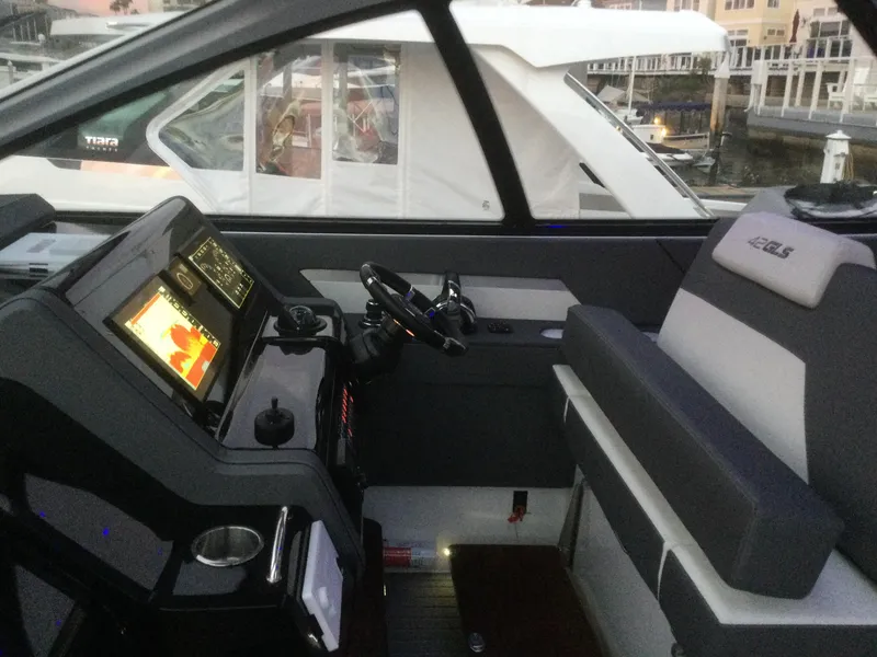 Slide: The Image of Interior cockpit of 2021 Cruisers Yachts 42 GLS OB with modern navigation system. - 38
