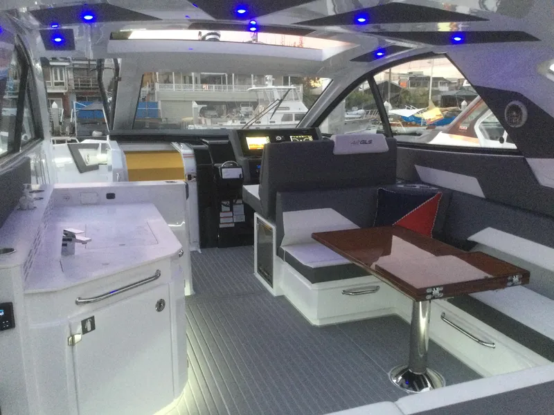 Slide: The Image of Luxurious interior of 2021 Cruisers Yachts 42 GLS OB with modern seating and ambient lighting. - 40