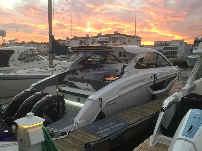 Slide: The Image of 2021 Cruisers Yachts 42 GLS OB docked at sunset, featuring sleek design and powerful engines. - 41