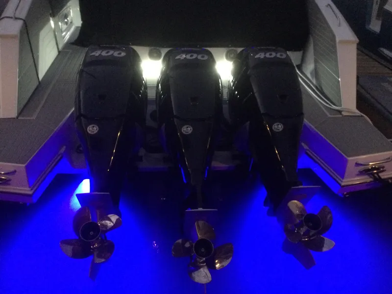 Slide: The Image of 2021 Cruisers Yachts 42 GLS OB with triple 400 horsepower outboard engines, illuminated in blue. - 44