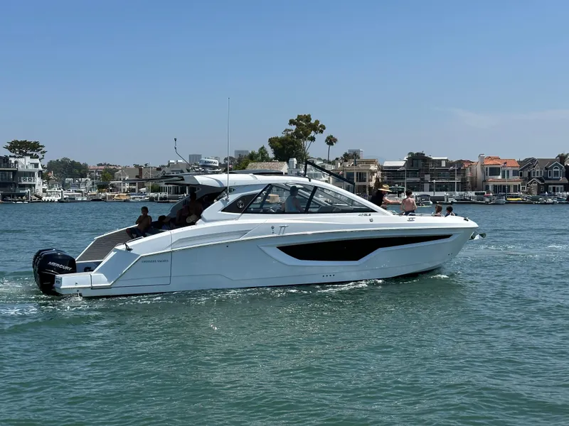 Slide: The Image of 2021 Cruisers Yachts 42 GLS OB on water, with people enjoying a sunny day. - 45