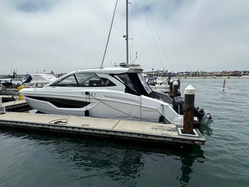 Slide: The Image of 2021 Cruisers Yachts 42 GLS OB docked at marina, side view. - 46