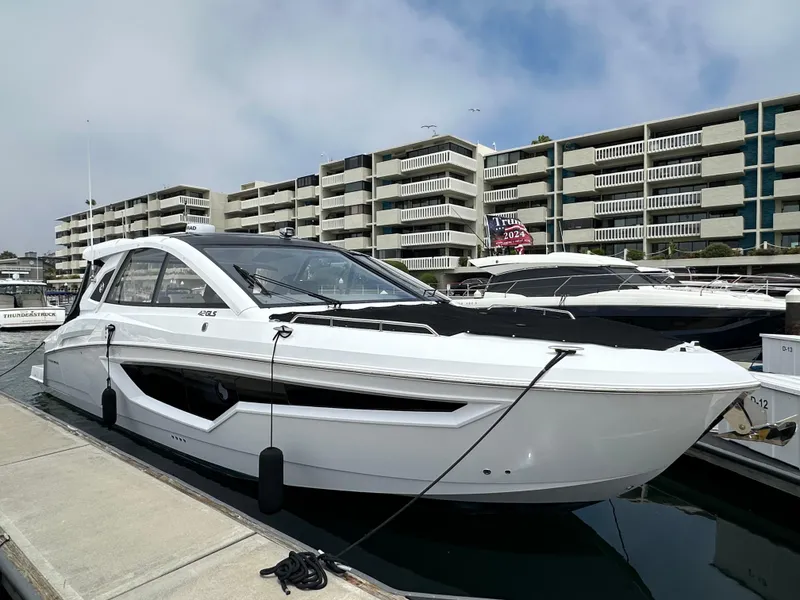 Slide: The Image of 2021 Cruisers Yachts 42 GLS OB docked at marina, modern design. - 48