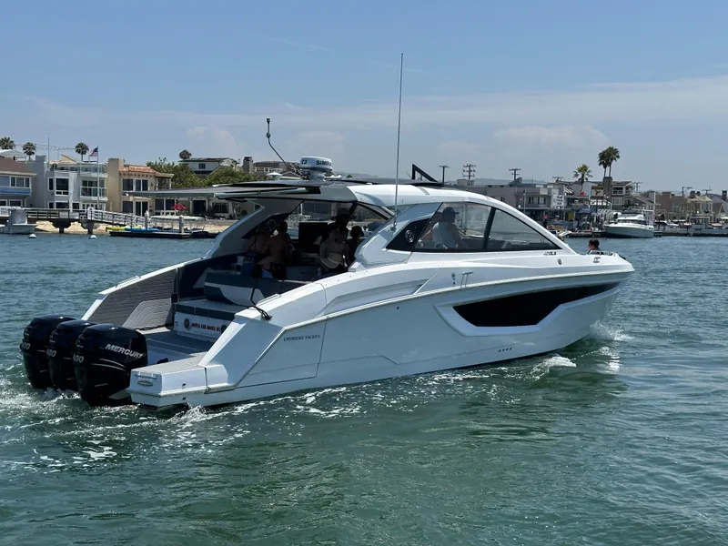 Slide: The Image of 2021 Cruisers Yachts 42 GLS OB on water, featuring triple Mercury outboard engines. - 51