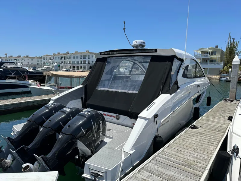 Slide: The Image of 2021 Cruisers Yachts 42 GLS OB docked with triple Mercury outboard engines. - 52