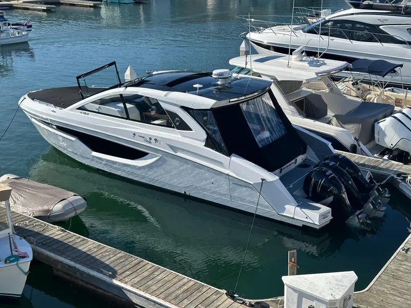 Slide: The Image of 2021 Cruisers Yachts 42 GLS OB docked in marina, sleek design, outboard engines. - 53