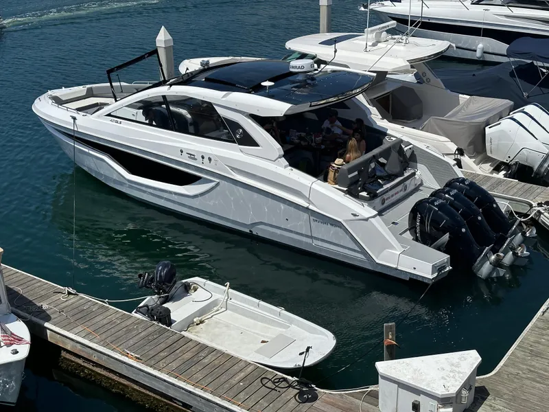 Slide: The Image of 2021 Cruisers Yachts 42 GLS OB docked at marina with triple outboard engines. - 55