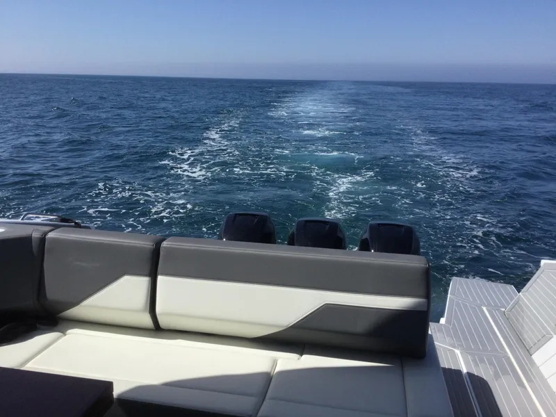 Slide: The Image of Cruisers Yachts 42 GLS OB 2021 on open sea, rear view with wake. - 56