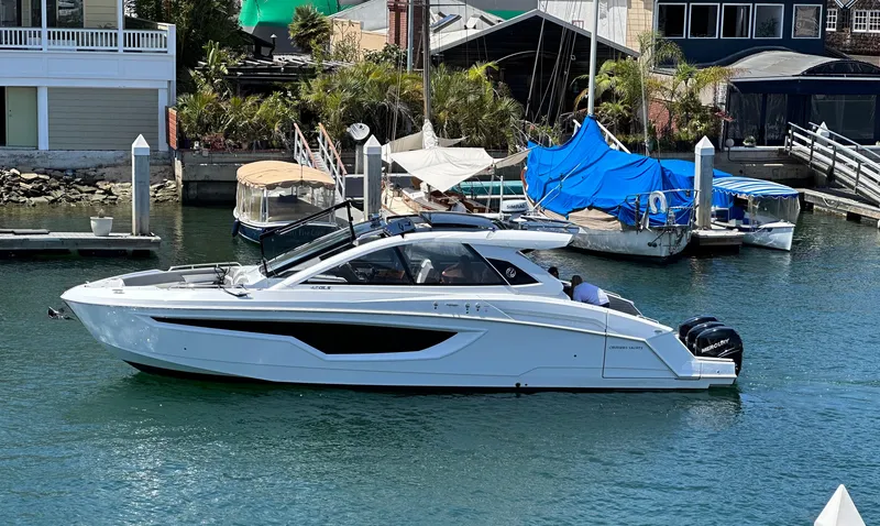 Slide: The Image of 2021 Cruisers Yachts 42 GLS OB in marina, sleek design, outboard engines. - 57