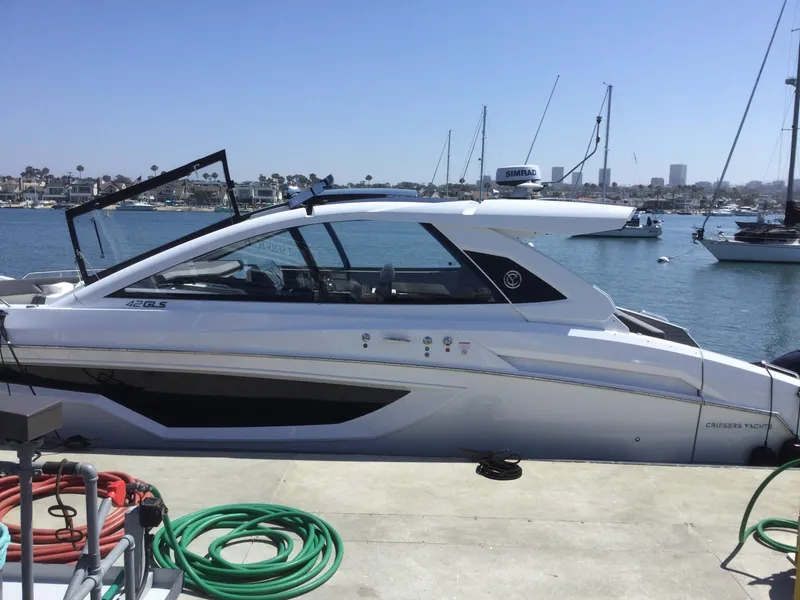 Slide: The Image of 2021 Cruisers Yachts 42 GLS OB docked in a marina, sunny day. - 58