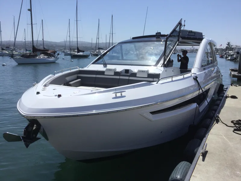 Slide: The Image of 2021 Cruisers Yachts 42 GLS OB docked in a marina. - 59