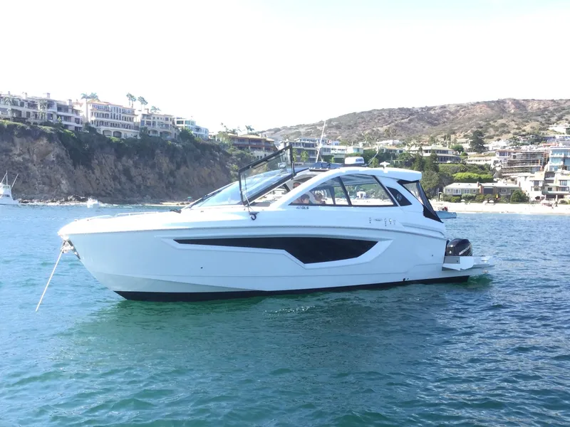 Slide: The Image of 2021 Cruisers Yachts 42 GLS OB on scenic coastal waters. - 60