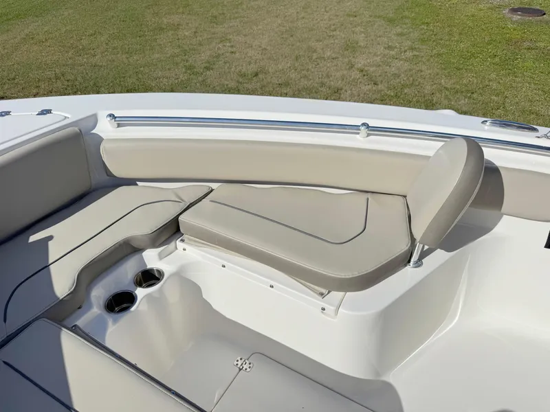 Slide: The Image of 2023 Key West 239 FS boat interior with beige seating and cup holders. - 11