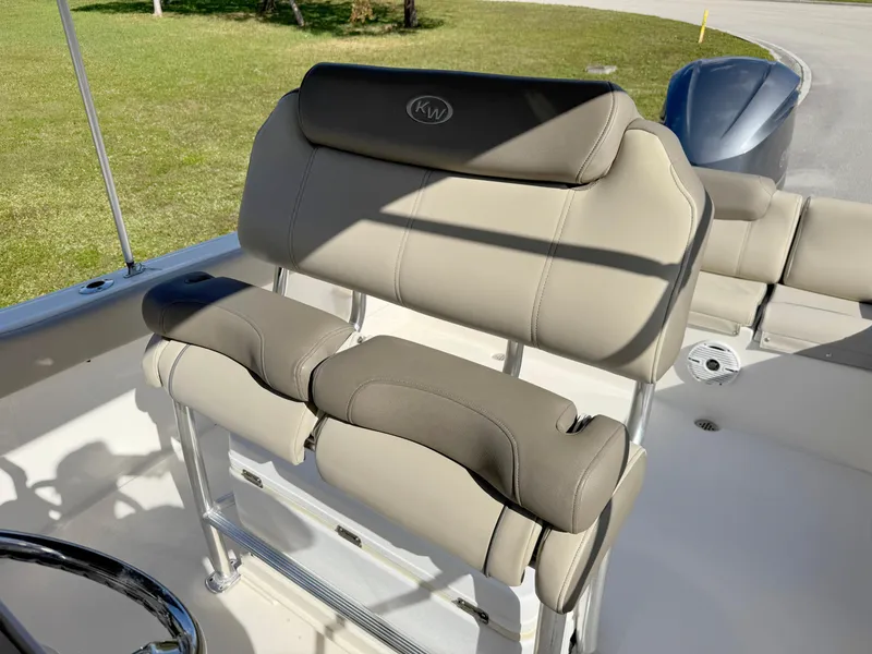 Slide: The Image of 2023 Key West 239 FS boat seating with beige upholstery and stainless steel frame. - 18