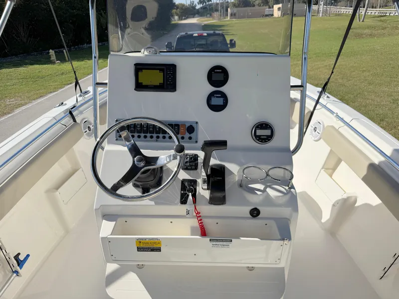 Slide: The Image of 2023 Key West 239 FS boat dashboard with steering wheel and controls. - 20
