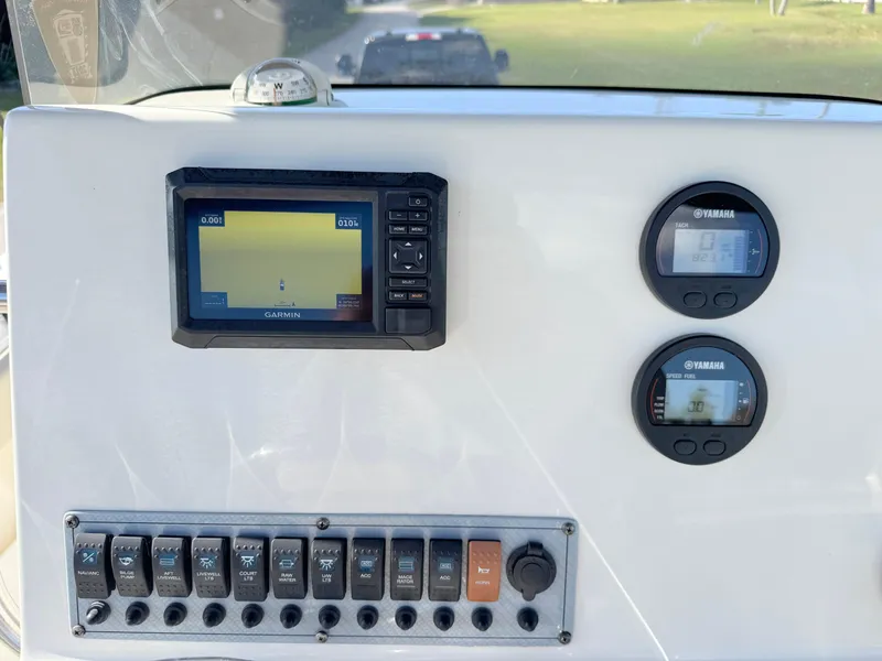 Slide: The Image of Key West 239 FS 2023 boat dashboard with Garmin and Yamaha displays. - 22