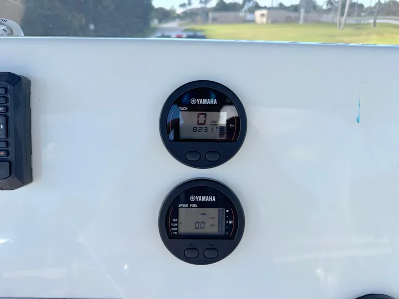 Slide: The Image of Yamaha gauges on 2023 Key West 239 FS boat dashboard, displaying tank and speed information. - 24