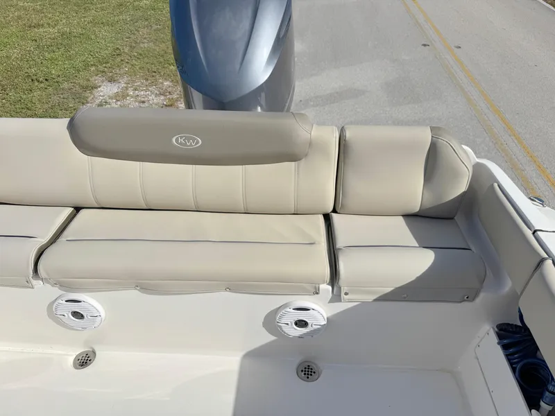 Slide: The Image of 2023 Key West 239 FS boat with beige seating and cup holders. - 26
