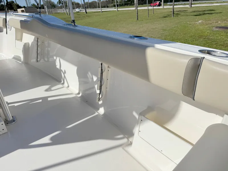 Slide: The Image of 2023 Key West 239 FS boat interior with beige seating and white deck. - 28