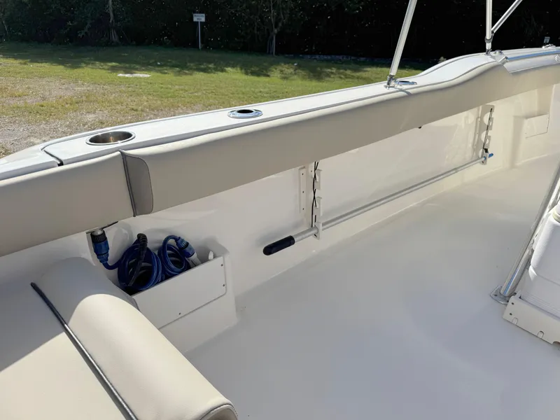 Slide: The Image of 2023 Key West 239 FS boat interior with cushioned seating and storage compartments. - 29