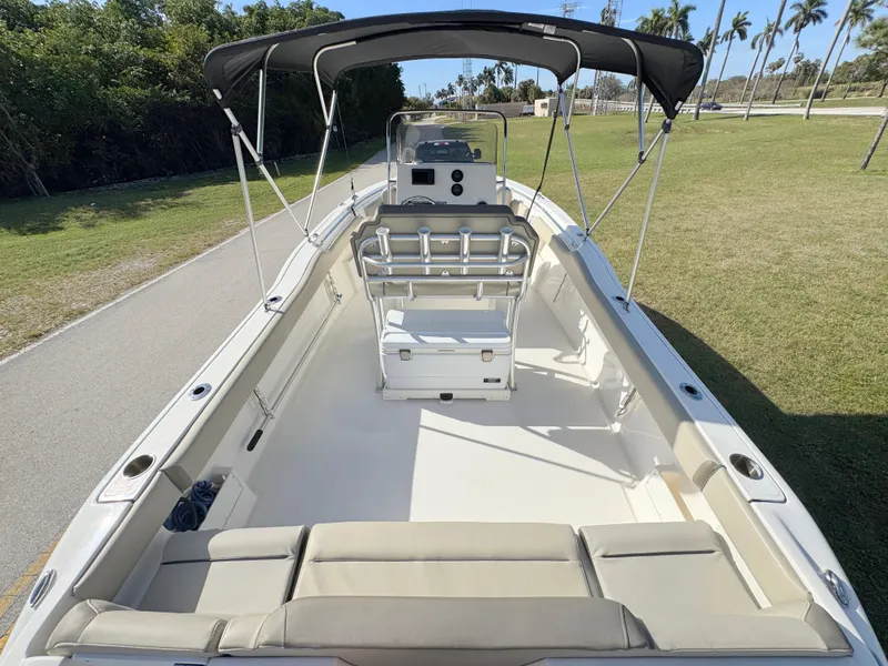 Slide: The Image of 2023 Key West 239 FS boat with spacious seating and canopy on grassy area. - 32