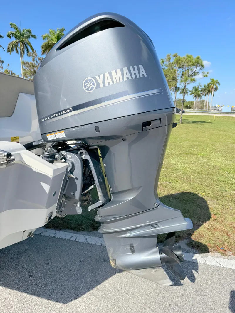 Slide: The Image of 2023 Key West 239 FS boat with Yamaha outboard motor in sunny park setting. - 33