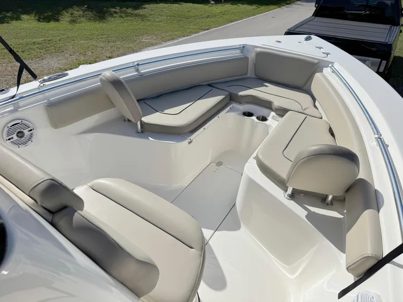 Slide: The Image of 2023 Key West 239 FS boat interior with cushioned seating and cup holders. - 8