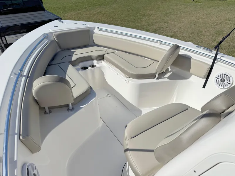 Slide: The Image of 2023 Key West 239 FS boat interior with beige seating and spacious layout. - 9