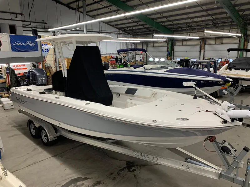 Slide: The Image of 2019 Robalo 246 Cayman boat on trailer in indoor showroom. - 10