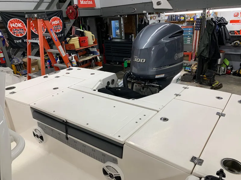 Slide: The Image of 2019 Robalo 246 Cayman boat with Yamaha 300 engine in a garage setting. - 14