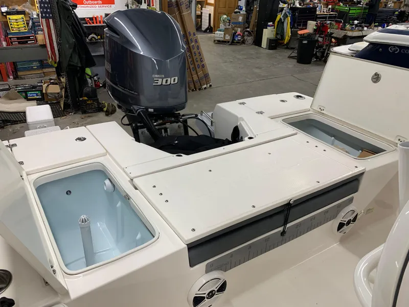 Slide: The Image of 2019 Robalo 246 Cayman boat with Yamaha 300 engine in a workshop setting. - 17
