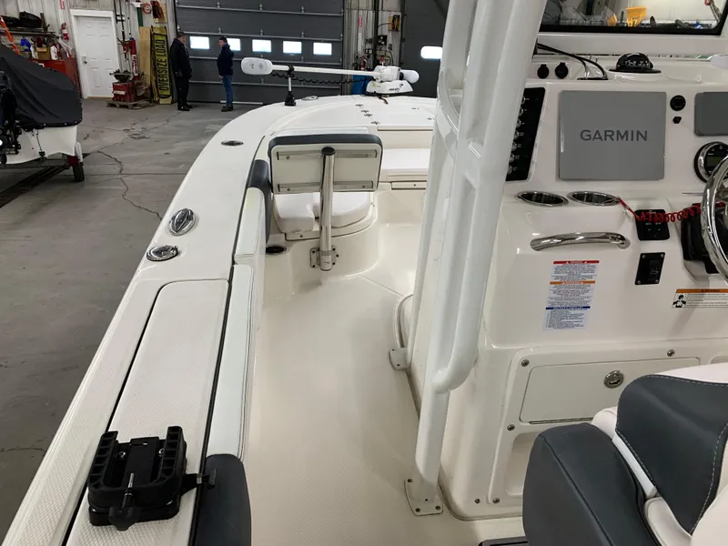 Slide: The Image of 2019 Robalo 246 Cayman boat interior with Garmin navigation system in a garage setting. - 21
