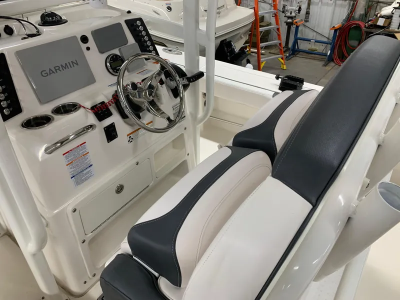 Slide: The Image of 2019 Robalo 246 Cayman boat interior with Garmin navigation system and dual seating. - 22