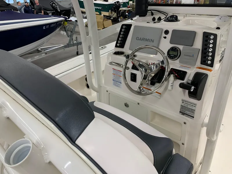 Slide: The Image of 2019 Robalo 246 Cayman boat console with Garmin navigation system and steering wheel. - 23