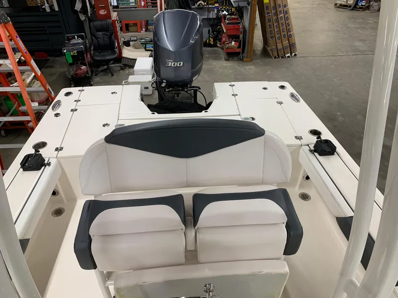 Slide: The Image of 2019 Robalo 246 Cayman boat interior with Yamaha 300 engine in a workshop setting. - 24