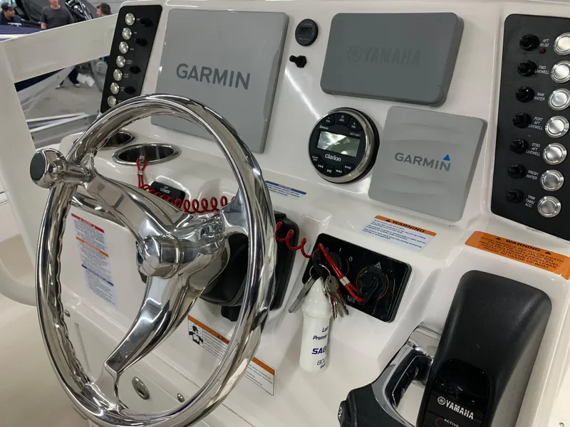 Slide: The Image of 2019 Robalo 246 Cayman boat dashboard with Garmin navigation and Yamaha controls. - 25