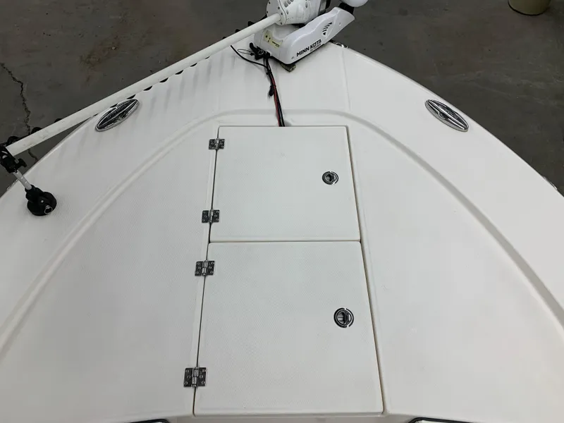 Slide: The Image of 2019 Robalo 246 Cayman boat deck with storage compartments and trolling motor. - 30