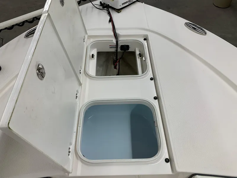 Slide: The Image of 2019 Robalo 246 Cayman boat storage compartments open on deck. - 31