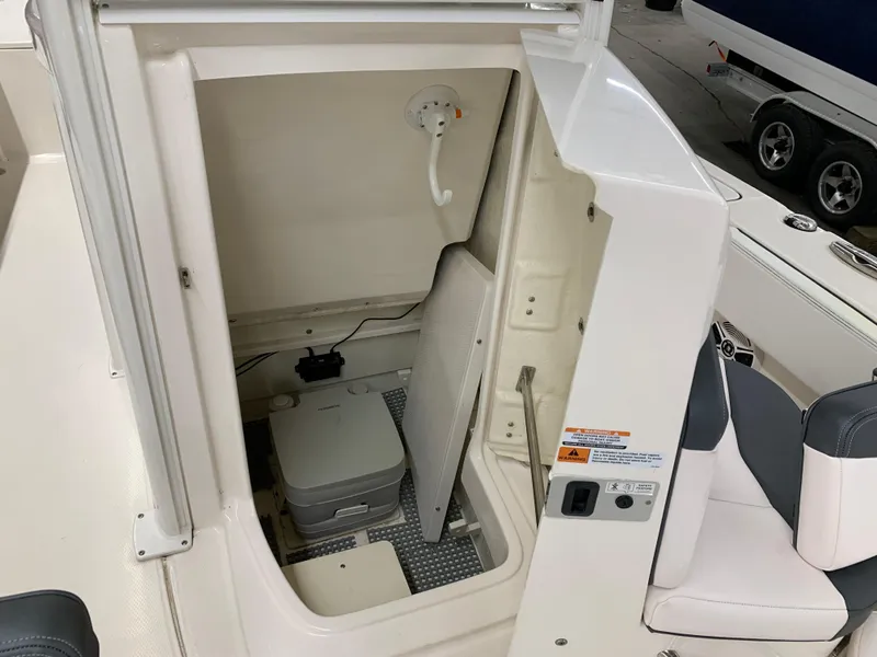 Slide: The Image of 2019 Robalo 246 Cayman boat interior with compact marine toilet. - 34
