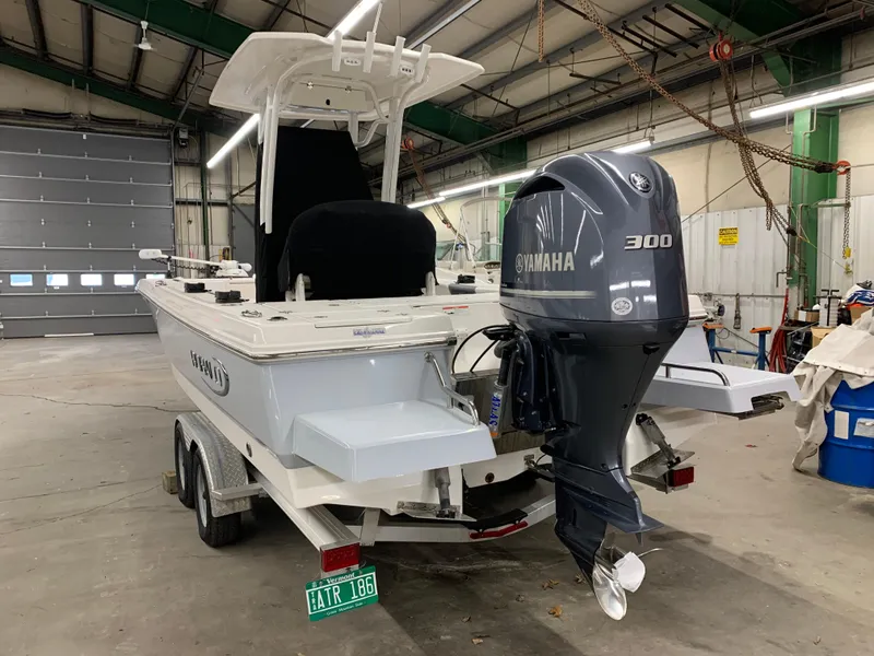 Slide: The Image of 2019 Robalo 246 Cayman boat with Yamaha 300 engine in a garage. - 7