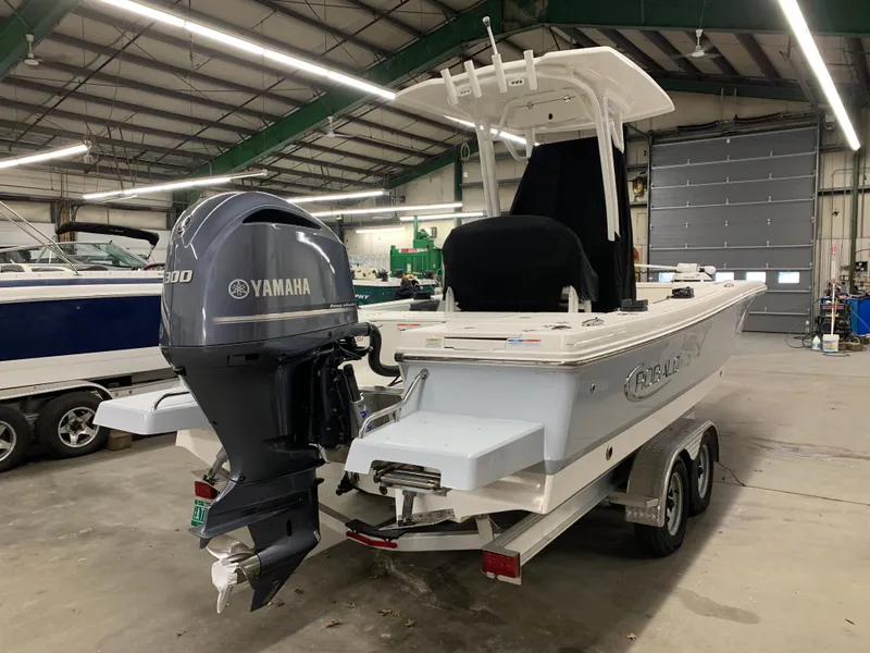 Slide: The Image of 2019 Robalo 246 Cayman boat with Yamaha engine in a warehouse. - 8