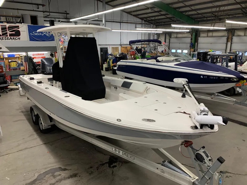 Slide: The Image of 2019 Robalo 246 Cayman boat in showroom, on trailer, side view. - 9
