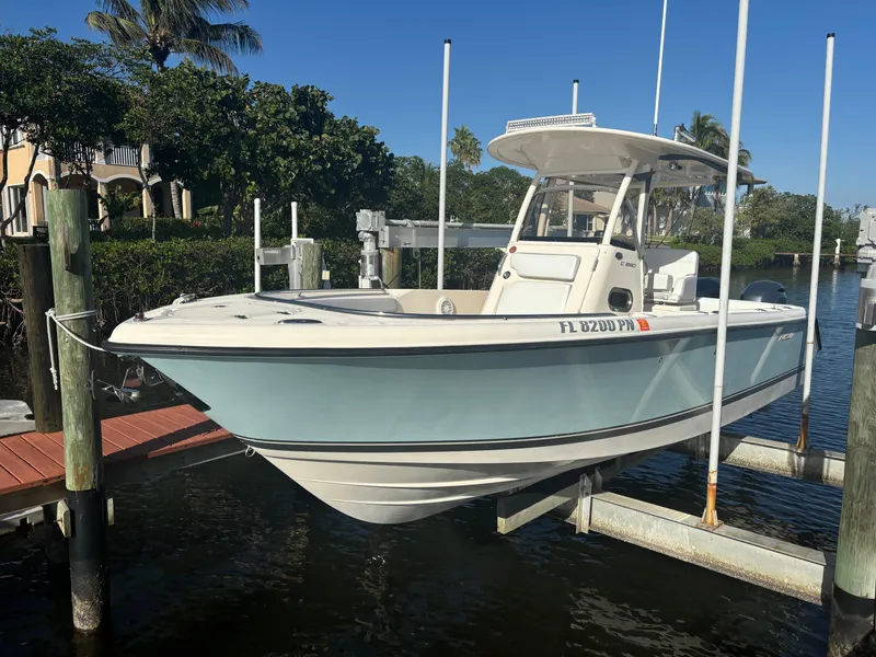The Image of 2014 Pursuit C 260 Center Console boat docked in a marina. - 1