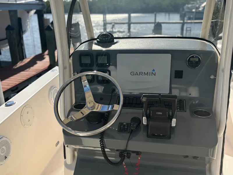 Slide: The Image of 2014 Pursuit C 260 Center Console boat dashboard with Garmin navigation system. - 11