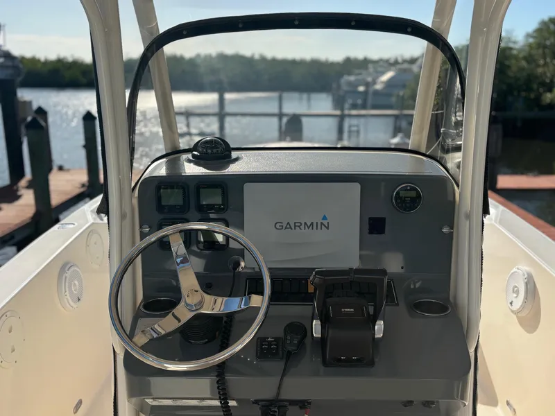 Slide: The Image of 2014 Pursuit C 260 Center Console boat dashboard with Garmin navigation system. - 12