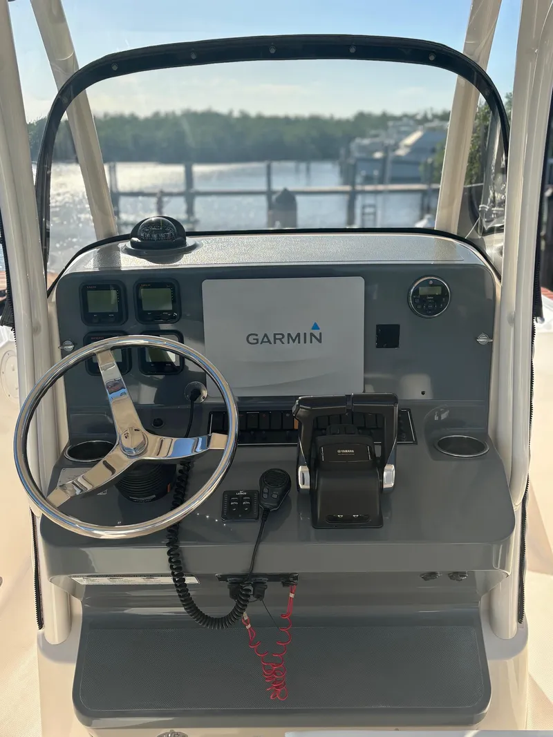 Slide: The Image of 2014 Pursuit C 260 Center Console boat dashboard with Garmin navigation system. - 13